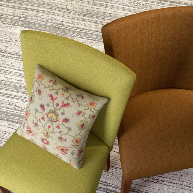 Green fabric chair with floral pillow