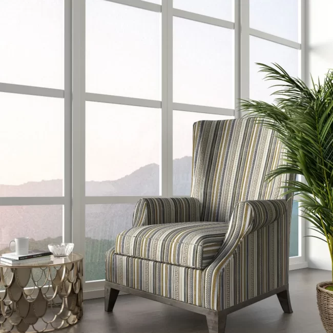 Striped high-back armchair near window
