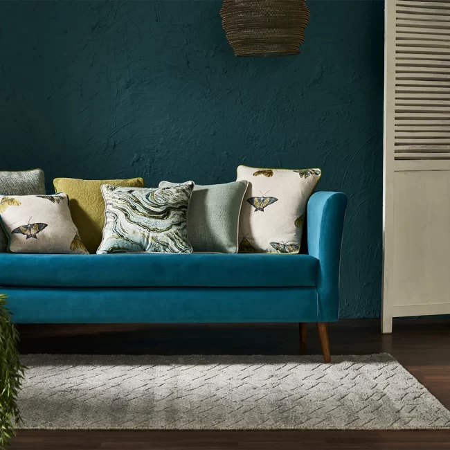Blue velvet sofa with cushions