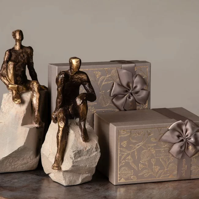 Bronze human sculptures with gift boxes